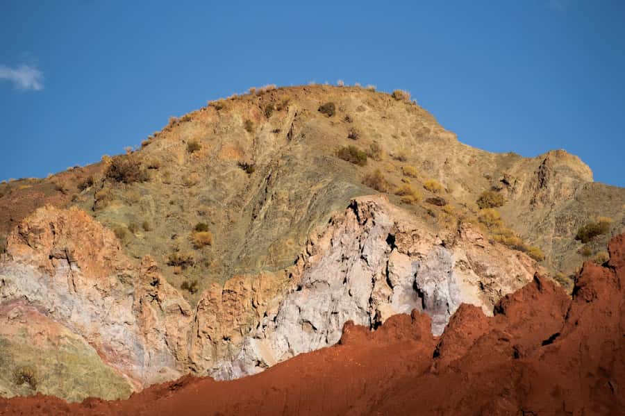 San Pedro de Atacama: Rainbow Valley & Hierbas Buenas Tour - Walking through the red, green, ochre, and white valley